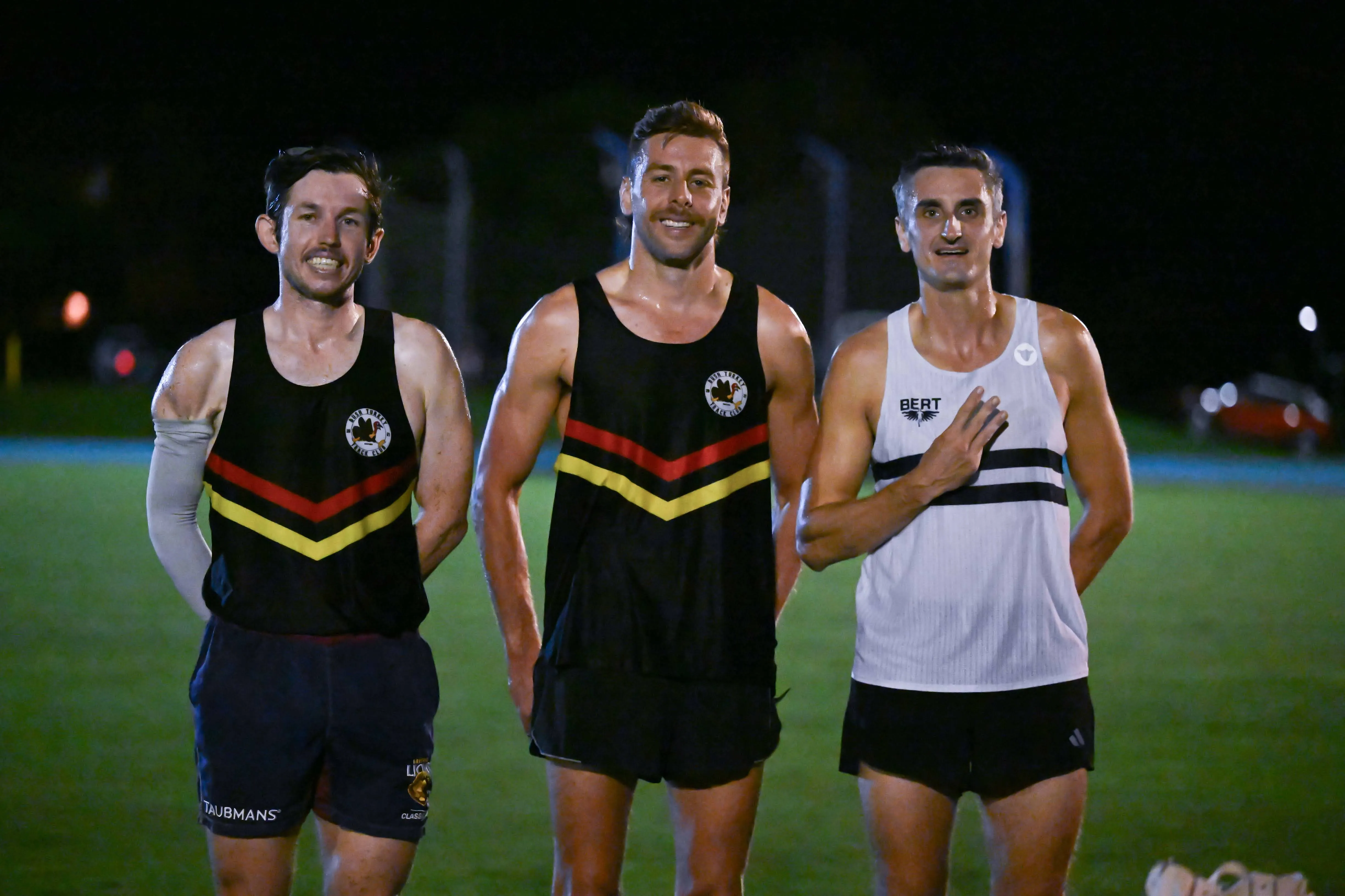 Three club runners lined up on the track before the Nudgee Gift 2025 handicap mile