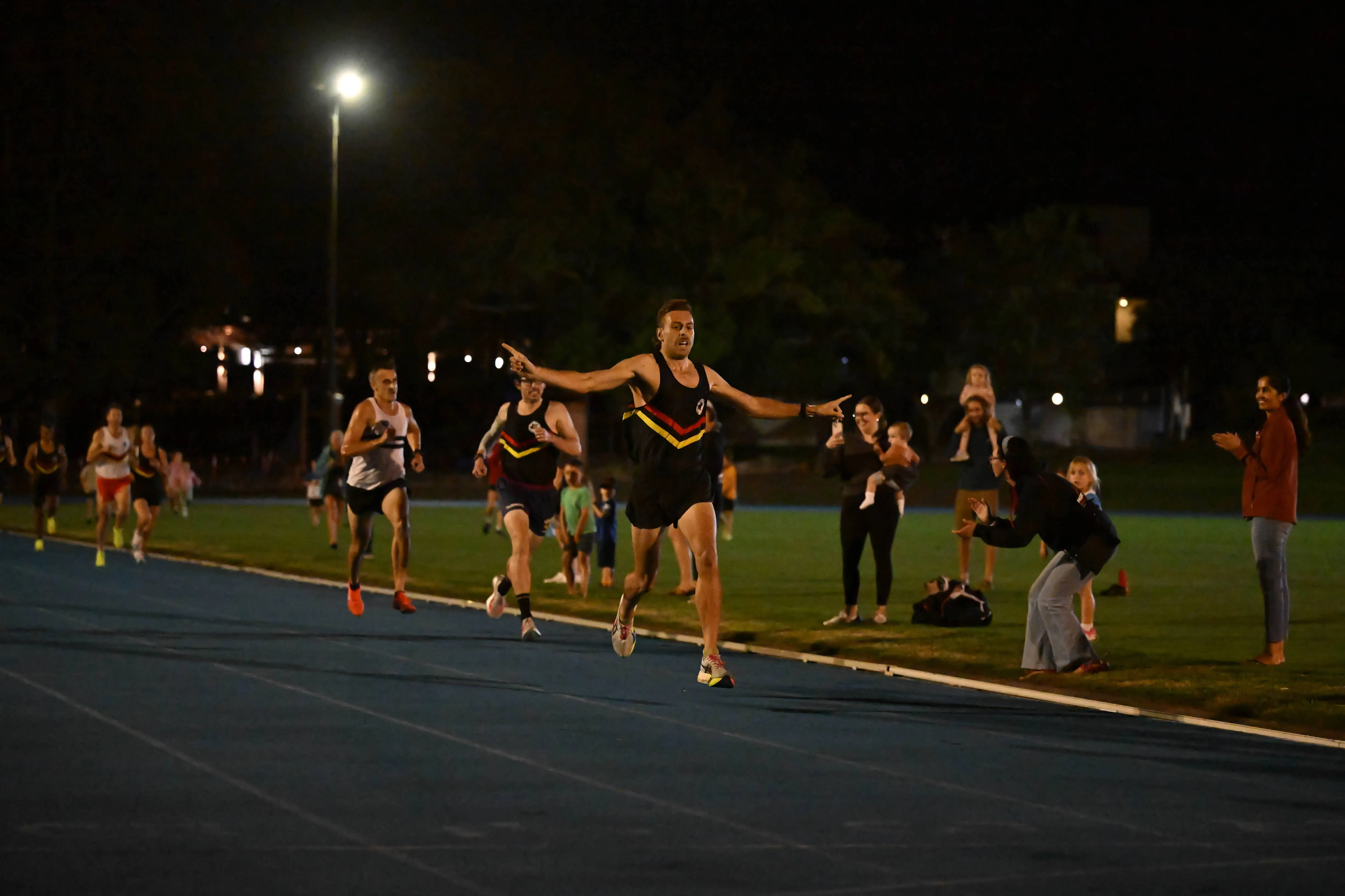Runners racing the handicap mile under lights