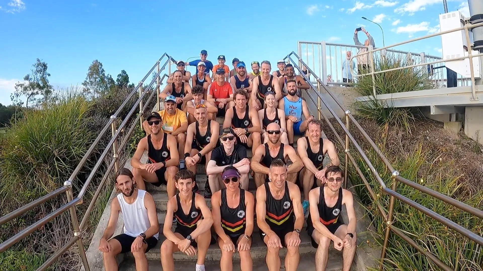 Round Two runners sitting on the steps at the Ted Smout Memorial Bridge